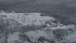 4K aerial stock footage flying by snowy King Ranch, forest, Sutton, Alaska Aerial Stock Footage | AK0001_0850