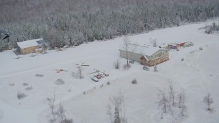 4K aerial stock footage ascend and fly away from snowy King Ranch, Sutton, Alaska Aerial Stock Footage | AK0001_0862