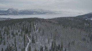 AK0001_0872 - 4K aerial stock footage approaching snow-covered mountains beyond the Matanuska Glacier, Alaska