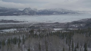 AK0001_0873 - 4K aerial stock footage approaching Matanuska Glacier near snow covered Chugach Mountains, during winter, Matanuska River Valley, Alaska