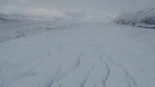 4K aerial stock footage approach distant snow-covered mountains, over the Matanuska Glacier, Alaska Aerial Stock Footage | AK0001_0875