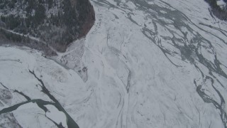 4K aerial stock footage bird's eye view of the icy, snow covered river during winter, Matanuska River Valley, Alaska Aerial Stock Footage | AK0001_0878