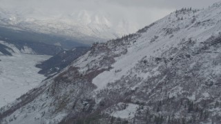 4K aerial stock footage rounding a snow-covered slope, Chugach Mountains, Alaska Aerial Stock Footage | AK0001_0879