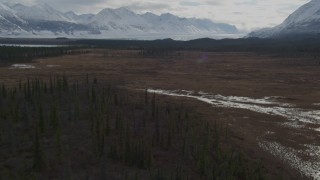 4K aerial stock footage flying over wilderness with snow, during winter toward Tazlina Glacier, Tazlina Lake, Alaska Aerial Stock Footage | AK0001_0913