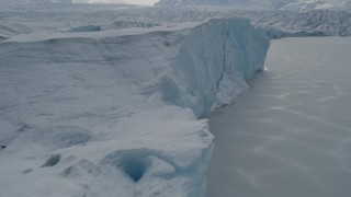 AK0001_0919 - 4K aerial stock footage flying along the edge of the snow-covered Tazlina Glacier, Alaska