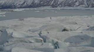 AK0001_0939 - 4K aerial stock footage approach Tazlina Lake, during winter, over edge of snow covered Tazlina Glacier, Alaska