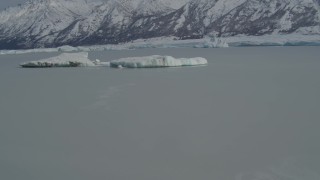 4K aerial stock footage fly over glacial ice toward snow covered Tazlina Glacier, during winter, Tazlina Lake, Alaska Aerial Stock Footage | AK0001_0940