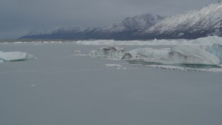 4K aerial stock footage flying near edge of snow covered glacier, during winter, over Tazlina Lake, Alaska Aerial Stock Footage | AK0001_0943