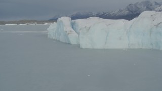 AK0001_0944 - 4K aerial stock footage flying over snow covered Tazlina Glacier and Tazlina Lake, during winter, Alaska