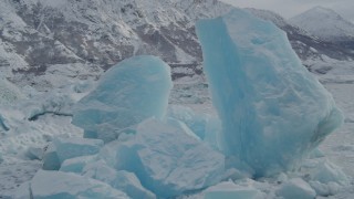 4K aerial stock footage fly by glacial ice near edge of glacier, during winter, in snow, Tazlina Lake, Alaska Aerial Stock Footage | AK0001_0947