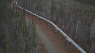 4K aerial stock footage a reverse view of the pipeline through forest in winter, Trans-Alaska Pipeline, Alaska Aerial Stock Footage | AK0001_0996