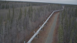 AK0001_0998 - 4K aerial stock footage pan across the pipeline during winter, Trans-Alaska Pipeline, Alaska