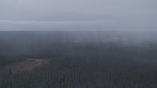 4K aerial stock footage flying by forest in the Alaskan Wilderness during a rain storm Aerial Stock Footage | AK0001_1018