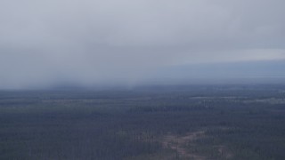 4K aerial stock footage flying away from low clouds over forest, Alaskan Wilderness Aerial Stock Footage | AK0001_1021