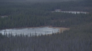 4K aerial stock footage flying past small ponds in the woods, Alaskan Wilderness Aerial Stock Footage | AK0001_1035