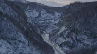 AK0001_1068 - 4K aerial stock footage following river at bottom of snow covered canyon, Talkeetna Mountains, Alaska