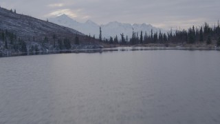 AK0001_1073 - 4K aerial stock footage fly over lake past cabins, reveal snowy Matanuska River Valley, Chugach Mountains, Alaska