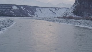 AK0001_1080 - 4K aerial stock footage flying over the Matanuska River and snow covered bank, Alaska