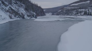 4K aerial stock footage racing along the Matanuska River, over snow covered bank, Alaska Aerial Stock Footage | AK0001_1083