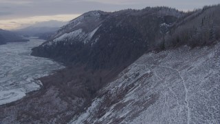 4K aerial stock footage ascending a snow covered cliff in the Matanuska River Valley, Alaska Aerial Stock Footage | AK0001_1095