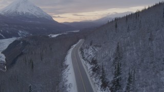 4K aerial stock footage Glenn Highway toward King Ranch, snow on ground, Sutton, Alaska, twilight Aerial Stock Footage | AK0001_1102