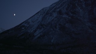 4K aerial stock footage the moon over the snow covered Chugach Mountains at night, Alaska Aerial Stock Footage | AK0001_1113