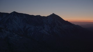 AK0001_1124 - 4K aerial stock footage flying toward snow covered Chugach Mountains at twilight, Alaska