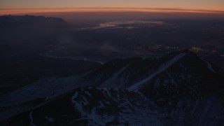 4K aerial stock footage snow covered Chugach Mountains toward Knik River Valley, Alaska, twilight Aerial Stock Footage | AK0001_1137