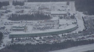 AK0001_1157 - 4K aerial stock footage snow covered buildings near Bryant Army Heliport, Anchorage, Alaska