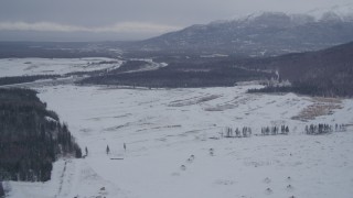 4K aerial stock footage Glenn Highway to snowy Chugach Mountains, Fort Richardson, Anchorage, Alaska Aerial Stock Footage | AK0001_1158