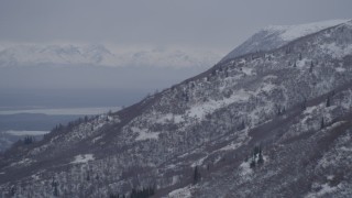 4K aerial stock footage flying along a snow covered slope in Chugach Mountains, Alaska Aerial Stock Footage | AK0001_1168