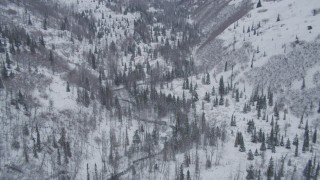 4K aerial stock footage ascend and tilt down on snowy, wooded river valley, Chugach Mountains, Alaska Aerial Stock Footage | AK0001_1203