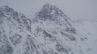 4K aerial stock footage flying toward snow covered peak in the Chugach Mountains, Alaska Aerial Stock Footage | AK0001_1205