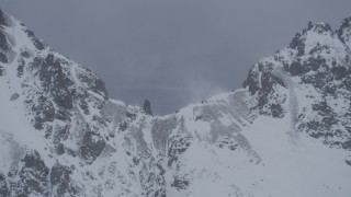 4K aerial stock footage wind blowing snow off summit of mountain ridge, Chugach Mountains, Alaska Aerial Stock Footage | AK0001_1206