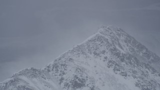 4K aerial stock footage wind blowing snow off mountain peak, Chugach Mountains, Alaska Aerial Stock Footage | AK0001_1209