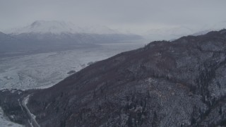 4K aerial stock footage fly away from snowy, wooded slopes, Knik River Valley, Chugach Mountains, Alaska Aerial Stock Footage | AK0001_1214