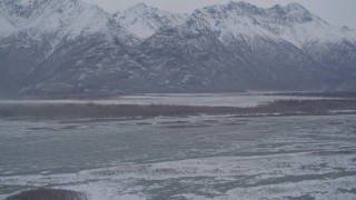 4K aerial stock footage flying toward lake, snow capped mountains in the Knik River Valley, Alaska Aerial Stock Footage | AK0001_1218