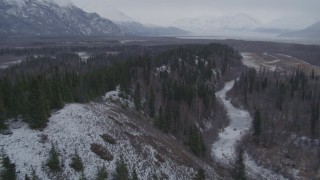 4K aerial stock footage following a river next to wooded hills, Knik River Valley, Alaska Aerial Stock Footage | AK0001_1225