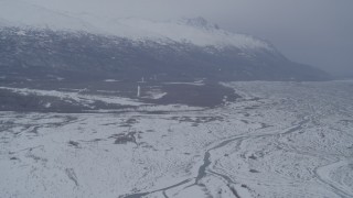 4K aerial stock footage flying toward base of snowy Chugach Mountains in Knik River Valley, Alaska Aerial Stock Footage | AK0001_1231