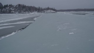 4K aerial stock footage following a river with ice sheets, Knik River Valley, Alaska in winter Aerial Stock Footage | AK0001_1265