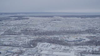 4K aerial stock footage flying past snow covered Elmendorf Air Force Base, Anchorage, Alaska Aerial Stock Footage | AK0001_1330