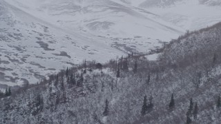 4K aerial stock footage rounding a snow covered slope revealing peaks of the Chugach Mountains, Alaska Aerial Stock Footage | AK0001_1335