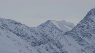 4K aerial stock footage a peak seen over a snowy ridge, Chugach Mountains, Alaska Aerial Stock Footage | AK0001_1348