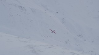 4K aerial stock footage tilting with airplane flying over snow covered slope, Chugach Mountains, Alaska Aerial Stock Footage | AK0001_1349