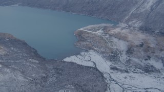 4K aerial stock footage Eklutna Lake surrounded by snow covered ground, Alaska Aerial Stock Footage | AK0001_1354