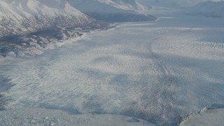 4K aerial stock footage a lake between base of mountain and the Knik Glacier in snow, Alaska Aerial Stock Footage | AK0001_1381