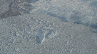 4K aerial stock footage an icy lake at edge of snow covered Knik Glacier, Alaska Aerial Stock Footage | AK0001_1382