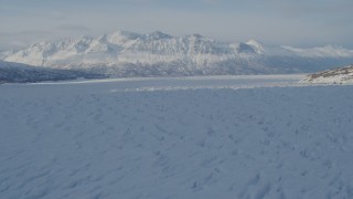 4K aerial stock footage flying across surface of snow covered Knik Glacier, Alaska Aerial Stock Footage | AK0001_1404