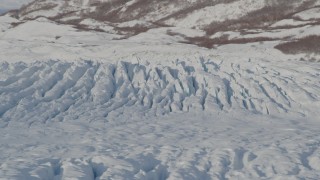 4K aerial stock footage flying past cracked, snow covered surface of Knik Glacier, Alaska Aerial Stock Footage | AK0001_1407