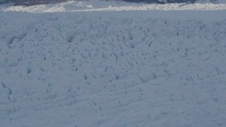 4K aerial stock footage the shadowed, snow covered surface of the Knik Glacier, Alaska Aerial Stock Footage | AK0001_1408